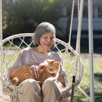files/elderly-woman-holding-ginger-cat-wheelchair.avif